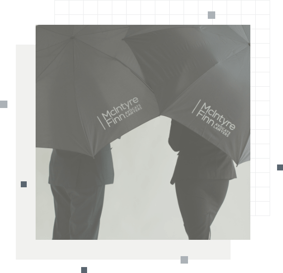 Two people holding umbrellas with the McIntyre Finn logo